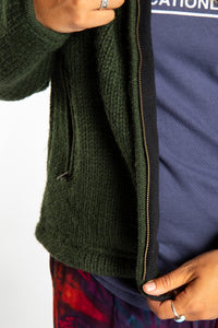 detail of zipper on olive green wool hooded jacket