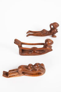 Wooden yoga sculpture in upward dog, bow pose, and mother and child