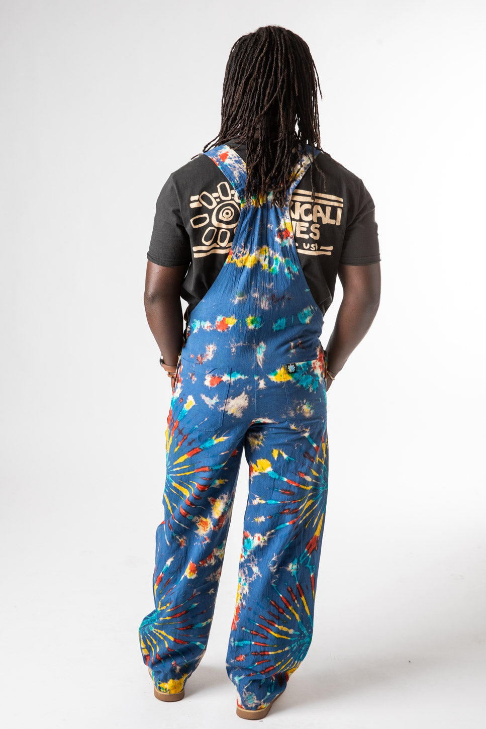 DJ is wearing size M tie dye overalls in blue