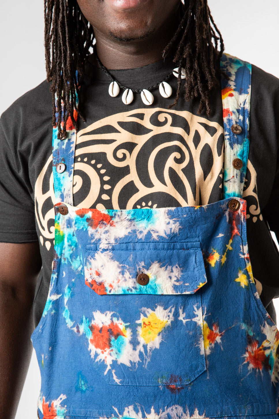 DJ is wearing size M tie dye overalls in blue