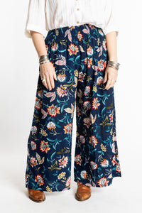 Susan is wearing the M/L Floral Blue Blooms Printed Penny Lane Pants