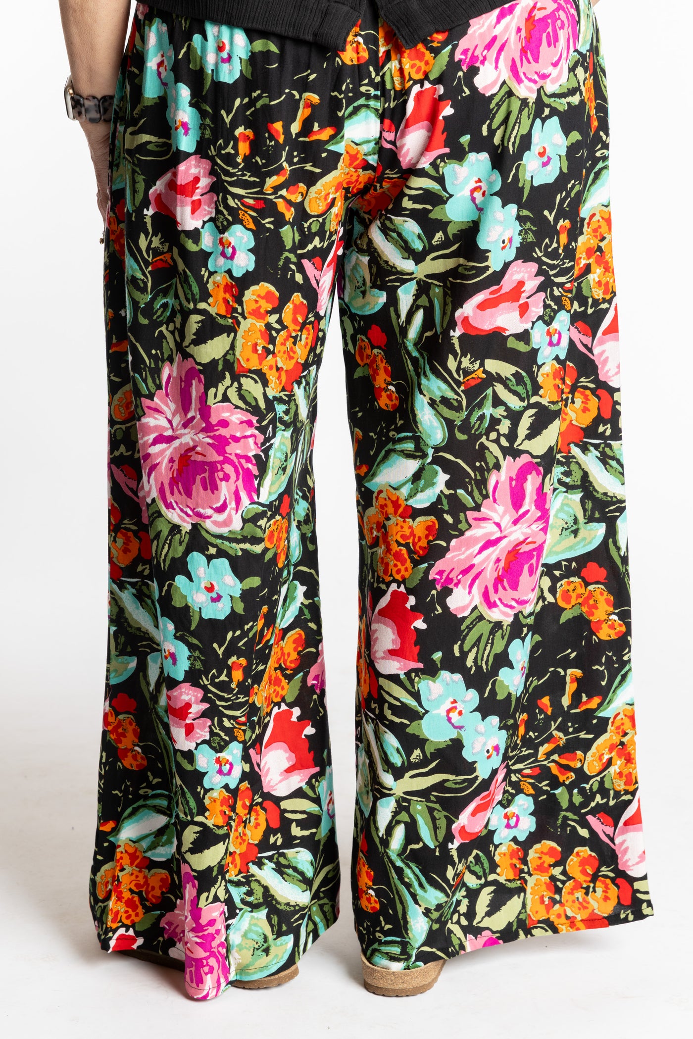 Betty is wearing the M/L Navy Floral Garden Printed Penny Lane Pants