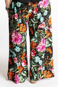 Betty is wearing the M/L Navy Floral Garden Printed Penny Lane Pants