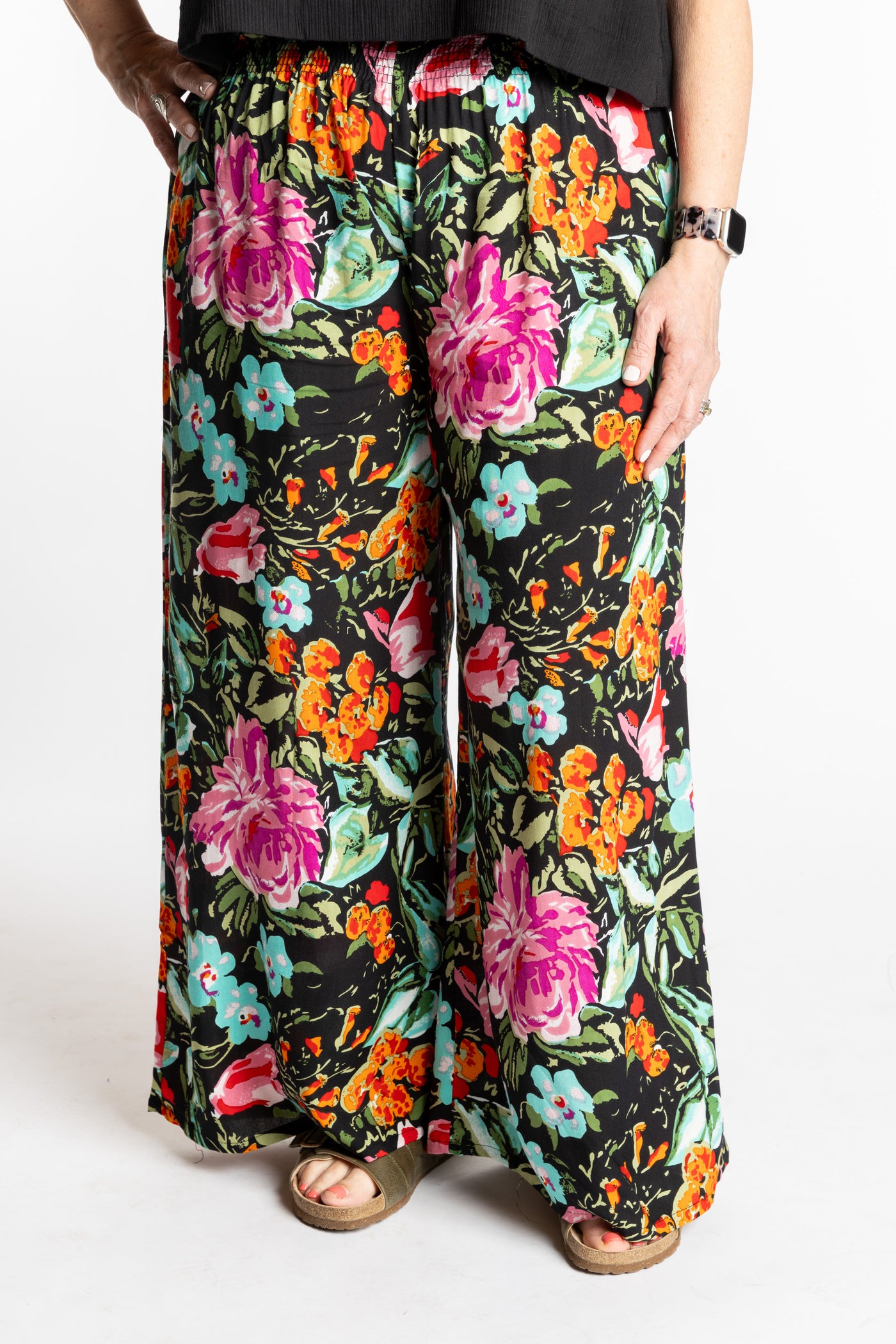 Betty is wearing the M/L Navy Floral Garden Printed Penny Lane Pants