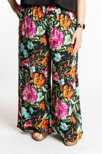 Betty is wearing the M/L Navy Floral Garden Printed Penny Lane Pants