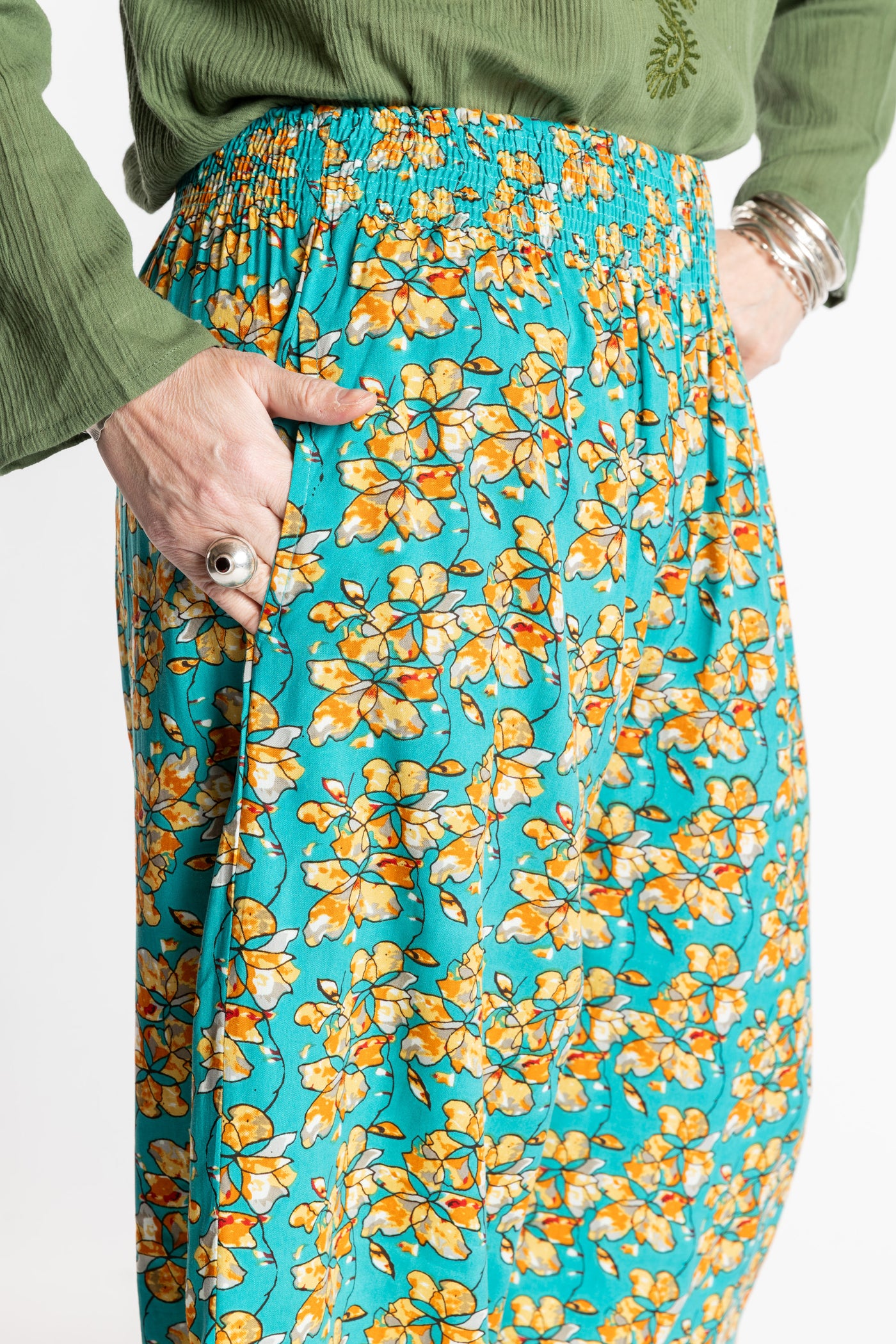 Susan is wearing the M/L Blue Floral Skyflower Printed Penny Lane Pants