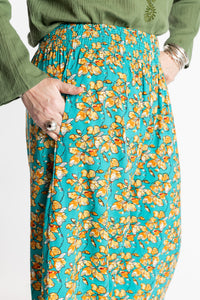 Susan is wearing the M/L Blue Floral Skyflower Printed Penny Lane Pants