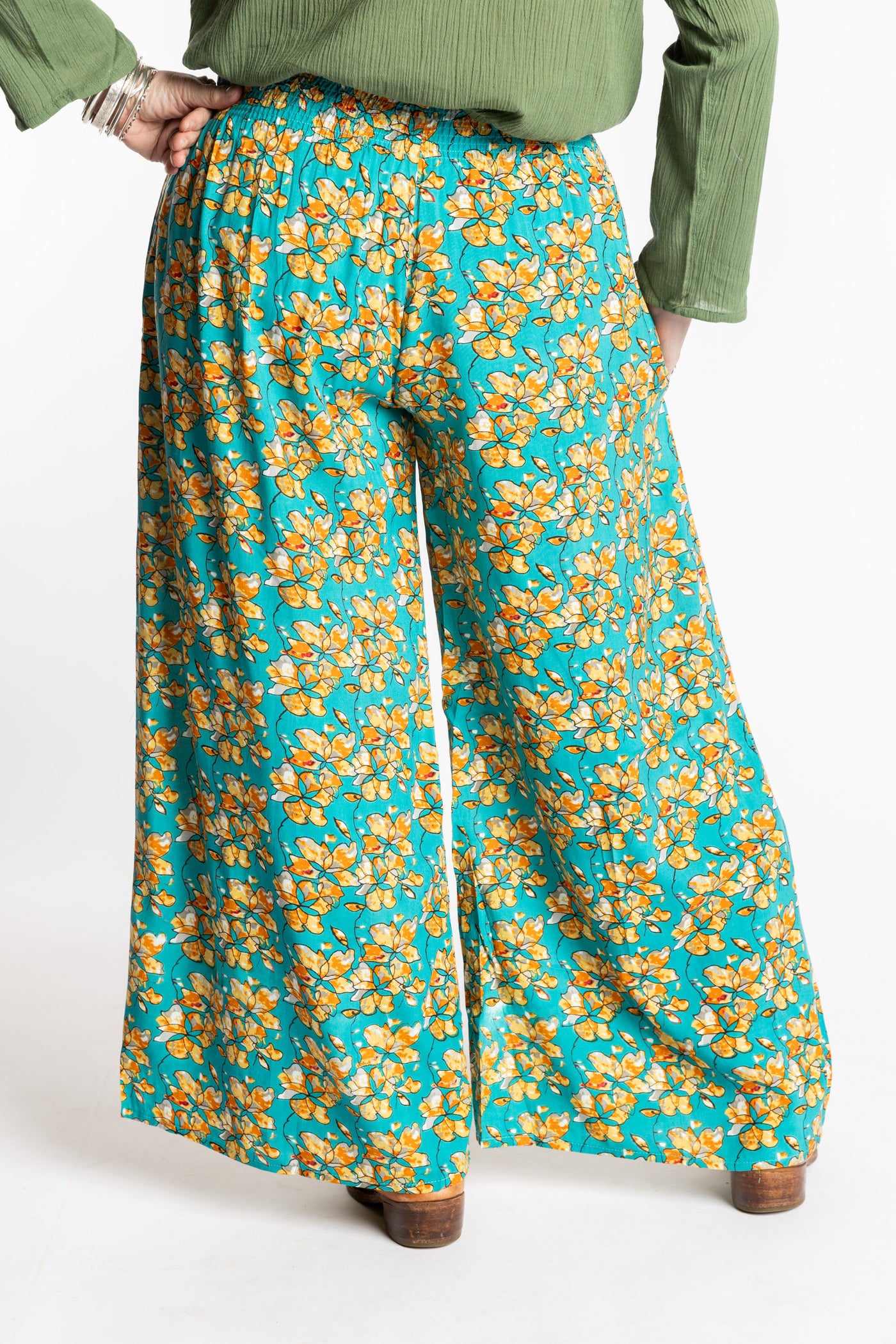 Susan is wearing the M/L Blue Floral Skyflower Printed Penny Lane Pants