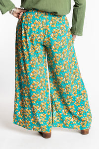 Susan is wearing the M/L Blue Floral Skyflower Printed Penny Lane Pants