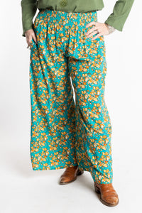 Susan is wearing the M/L Blue Floral Skyflower Printed Penny Lane Pants