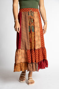 Sophie is wearing a red and orange patchwork silk prairie skirt in fire on the mountain