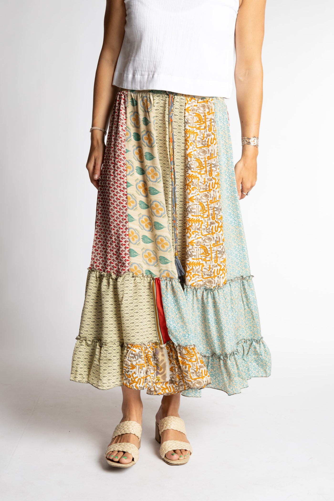 Sophie is wearing a mixed tan patchwork silk prairie skirt in jack straw