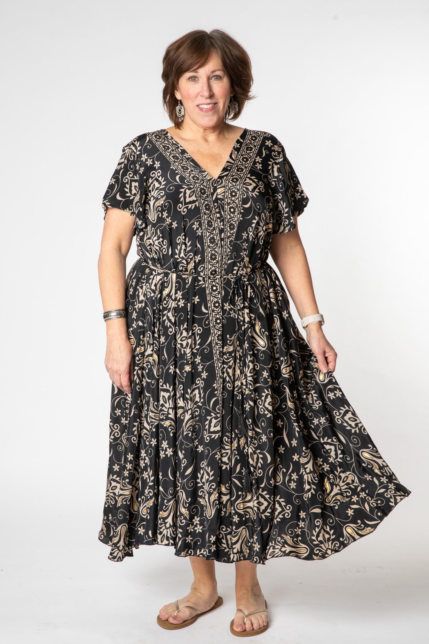 Betty is wearing a flowy dress in black vines