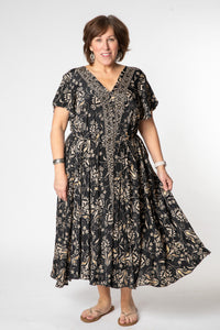 Betty is wearing a flowy dress in black vines