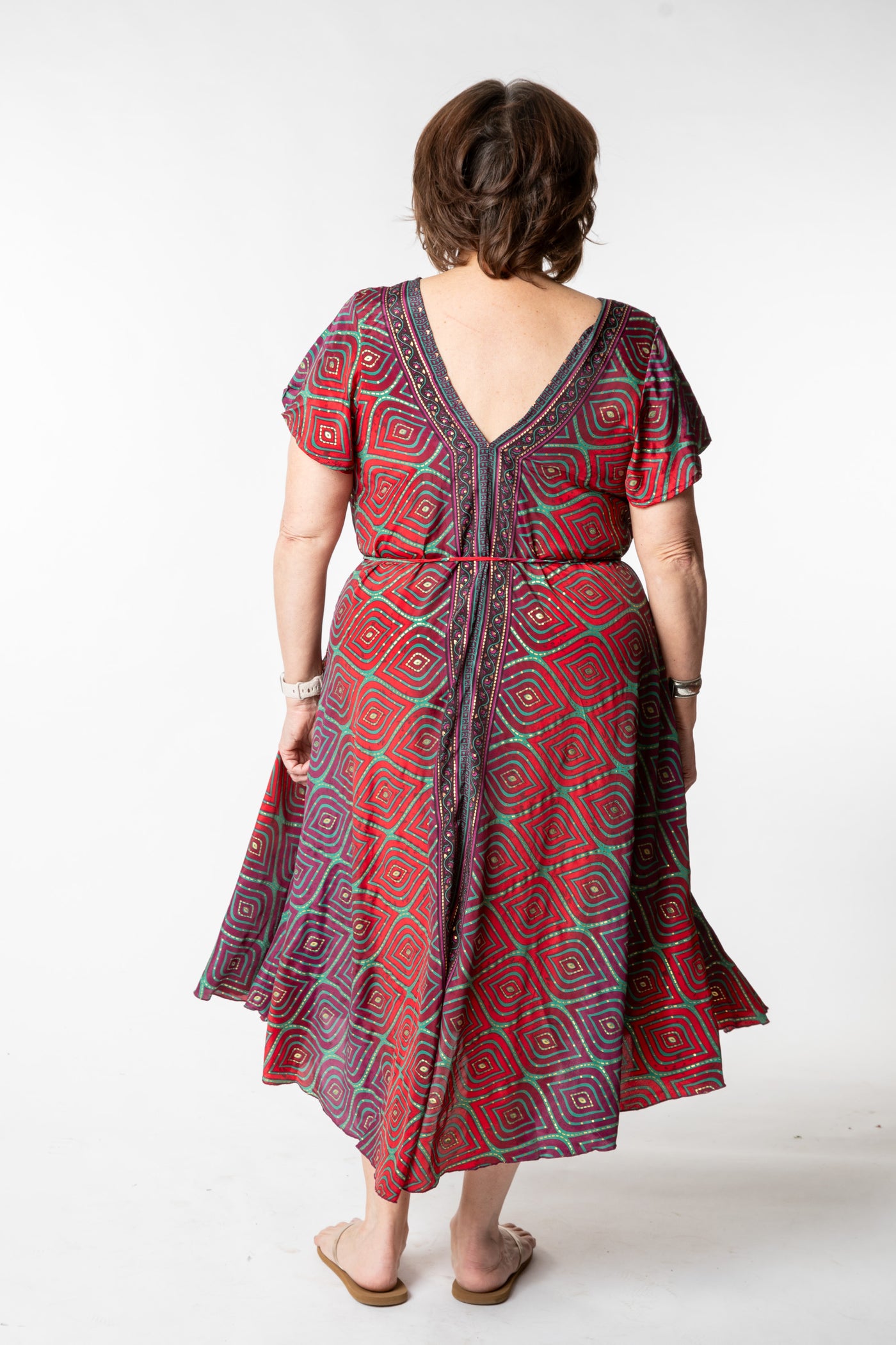 Betty is wearing a flowy dress in burgundy bulbs