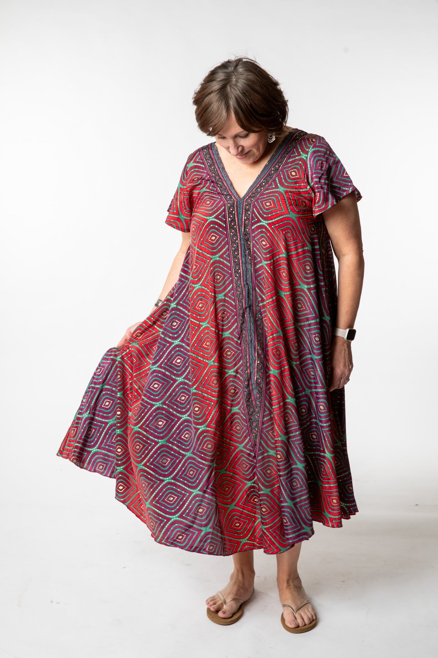 Betty is wearing a flowy dress in burgundy bulbs