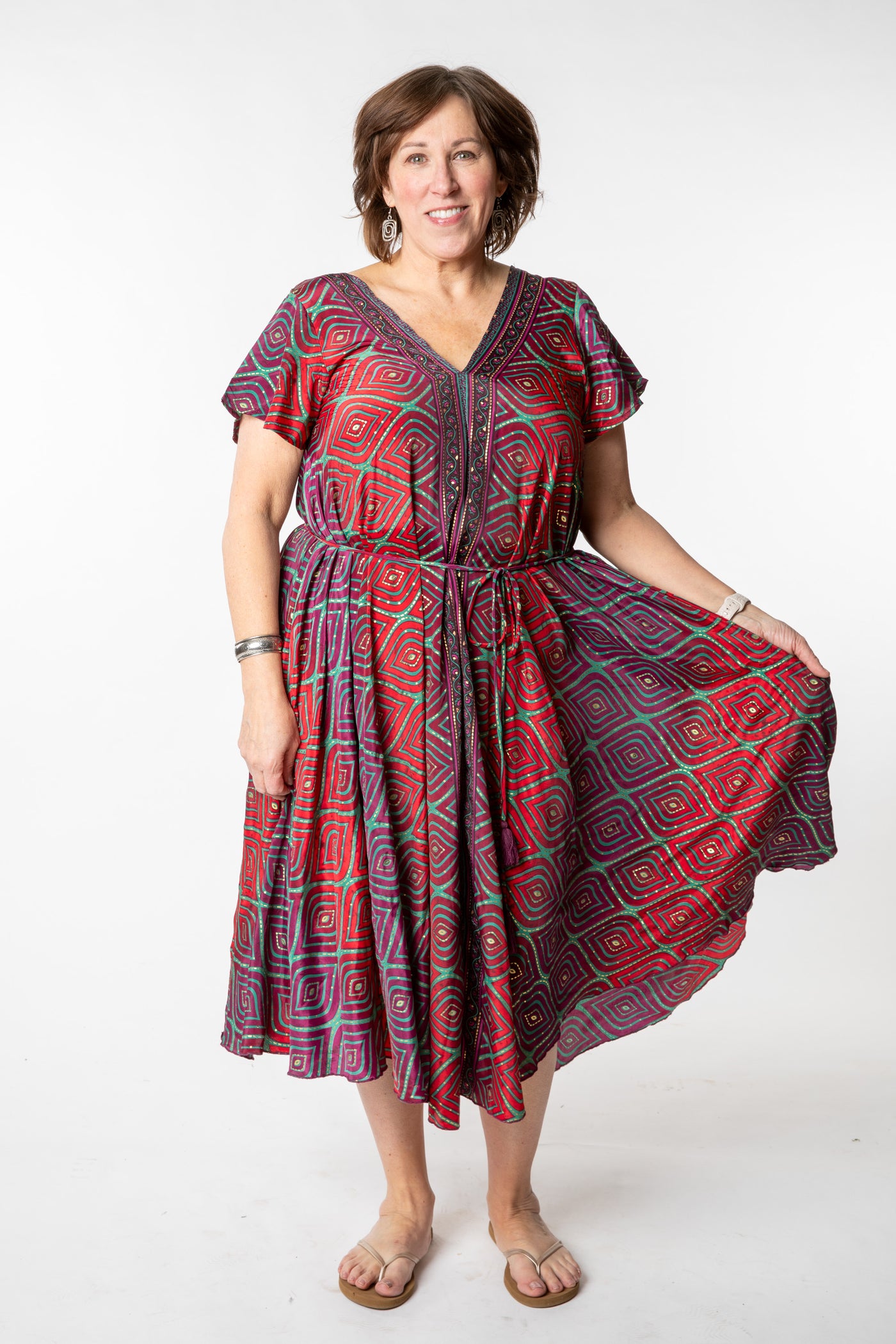 Betty is wearing a flowy dress in burgundy bulbs