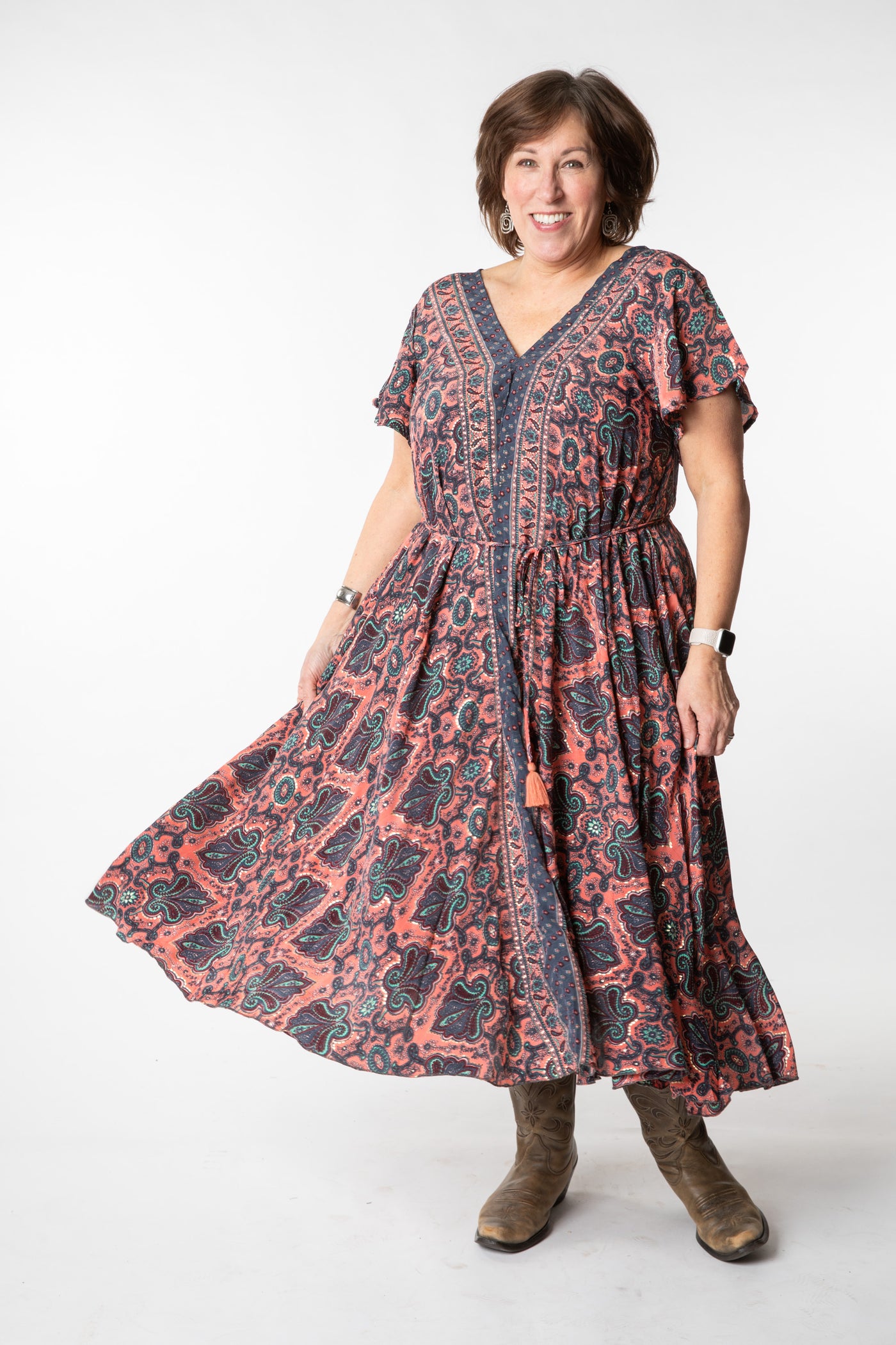 Betty is wearing a flowy dress in coral canopy