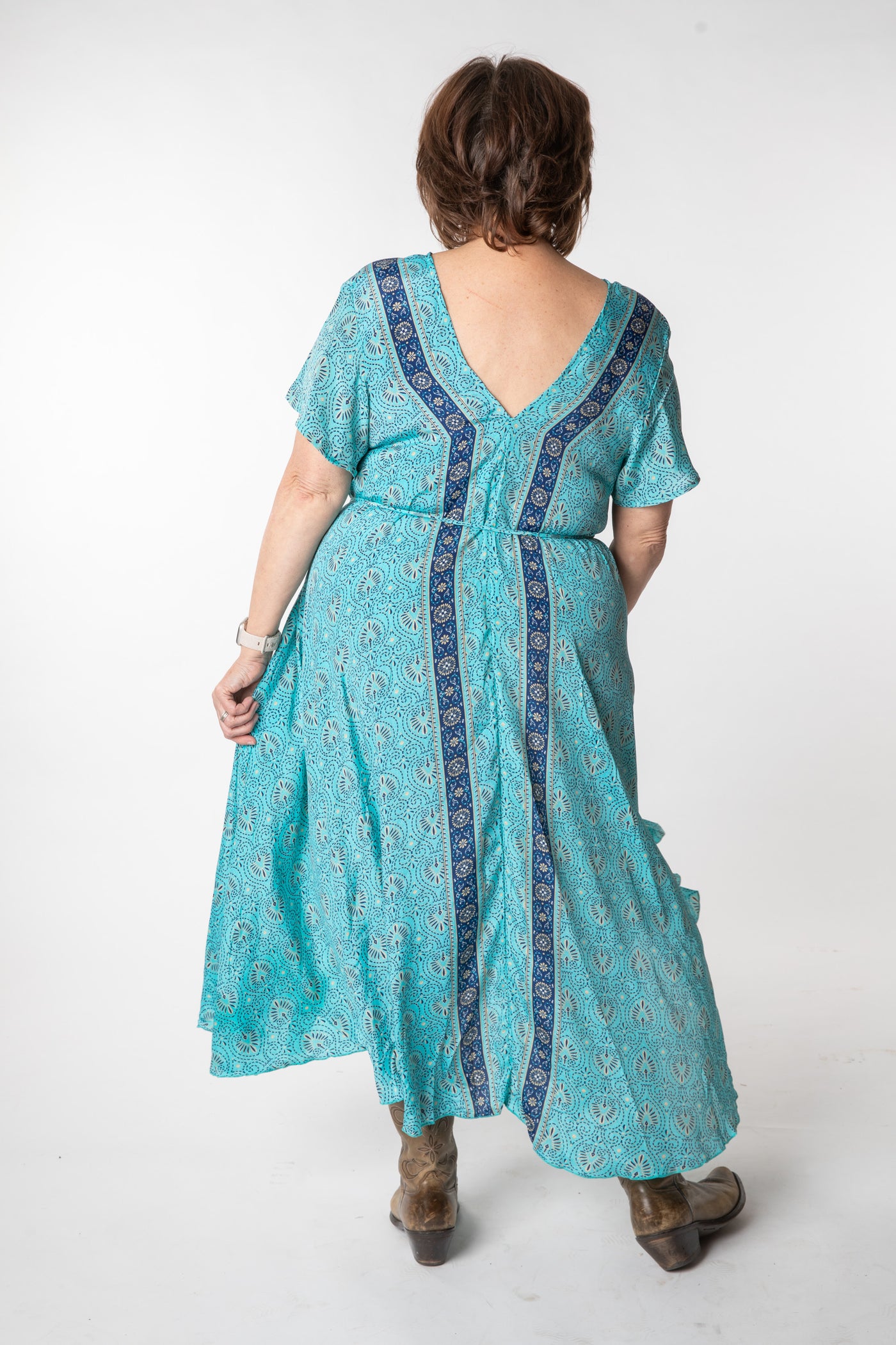 Betty is wearing a flowy dress in sky blue palms