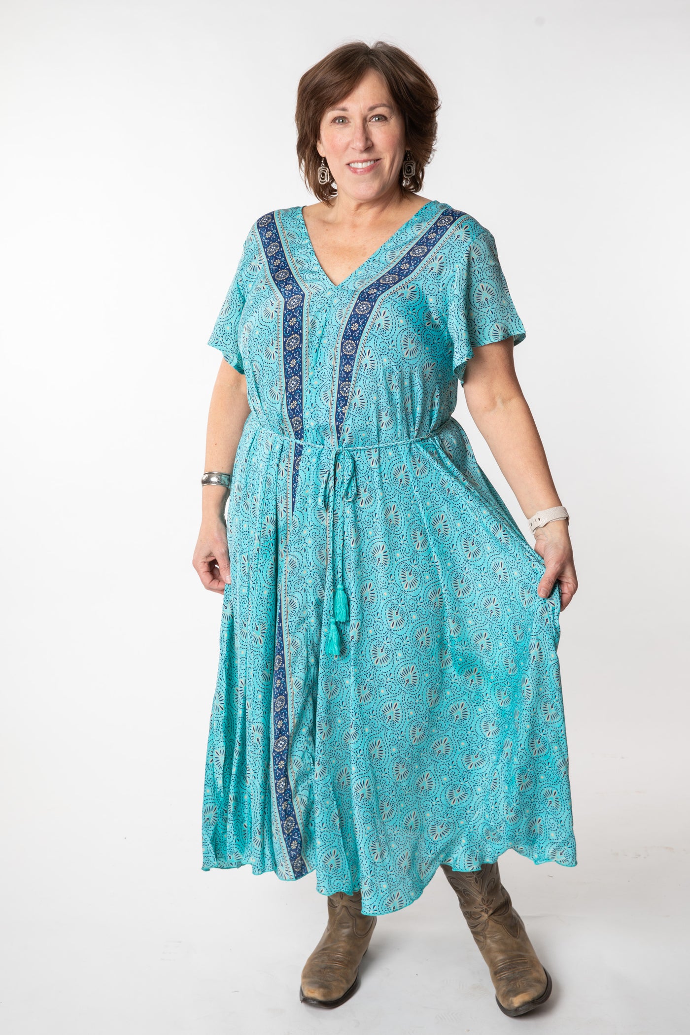 Betty is wearing a flowy dress in sky blue palms