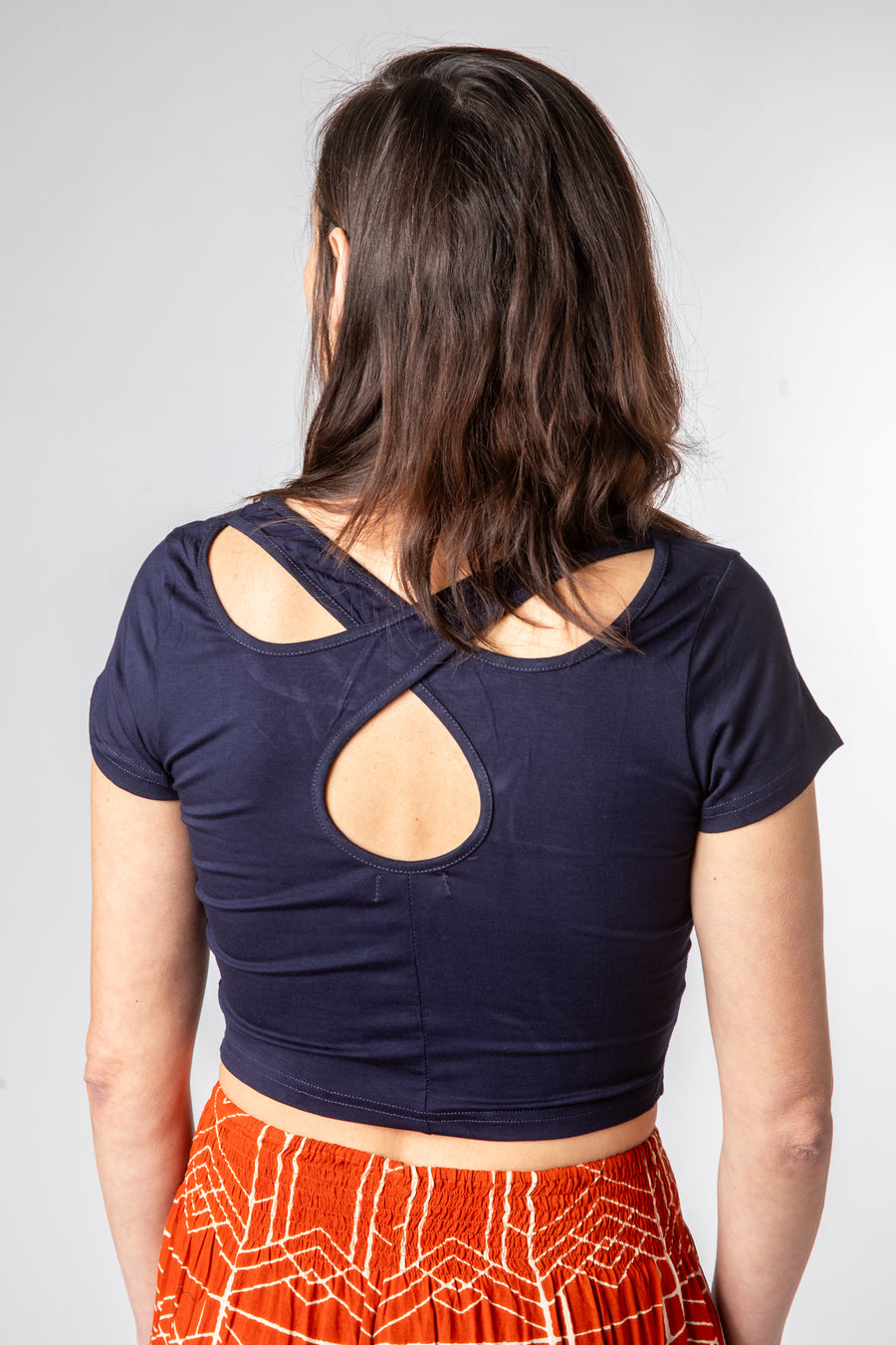 Emily is wearing size S cross back crop top in navy