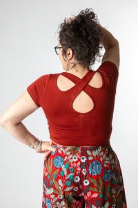 Susan is wearing size M cross back crop top in rust