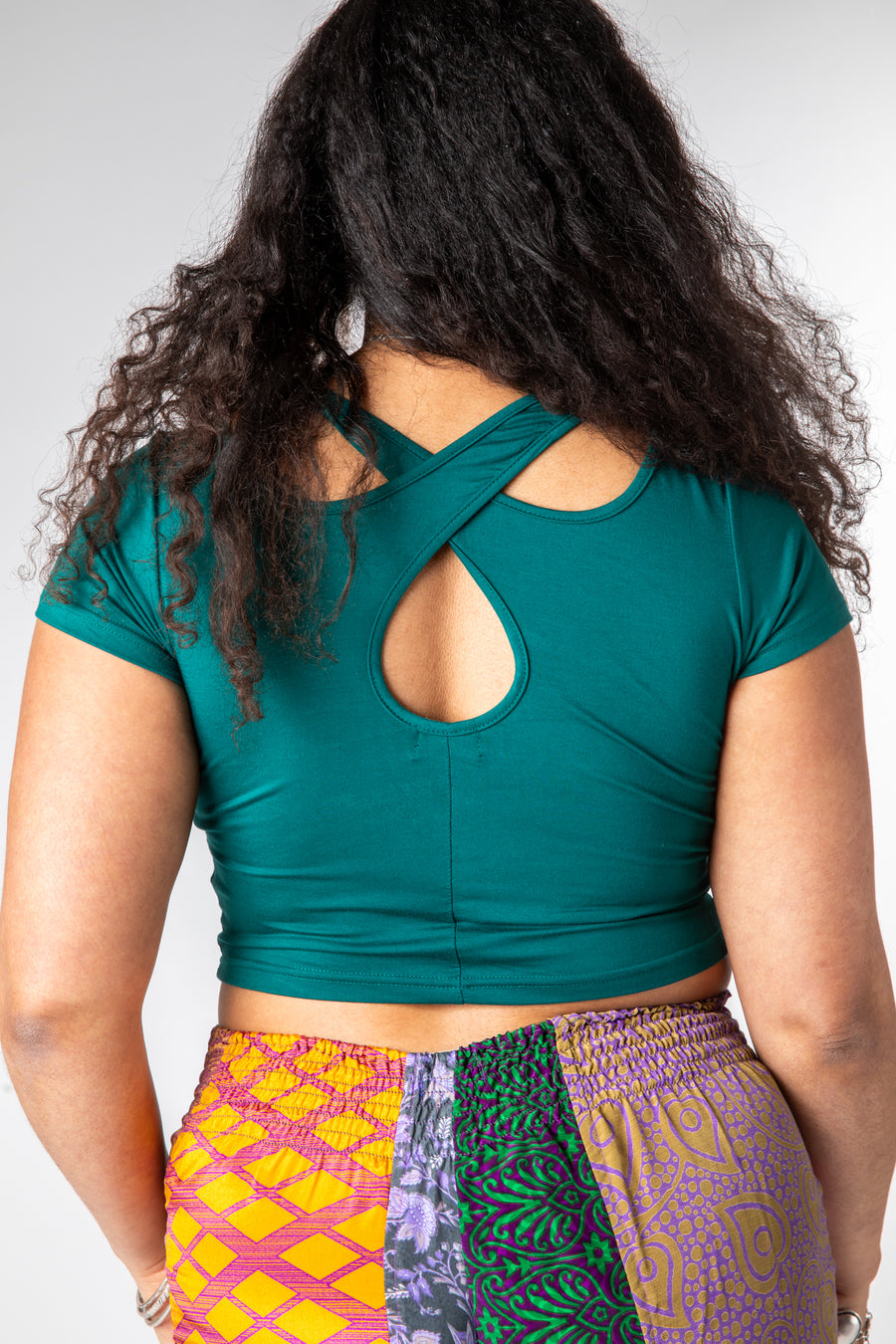 Lilly is wearing size M cross back crop top in teal