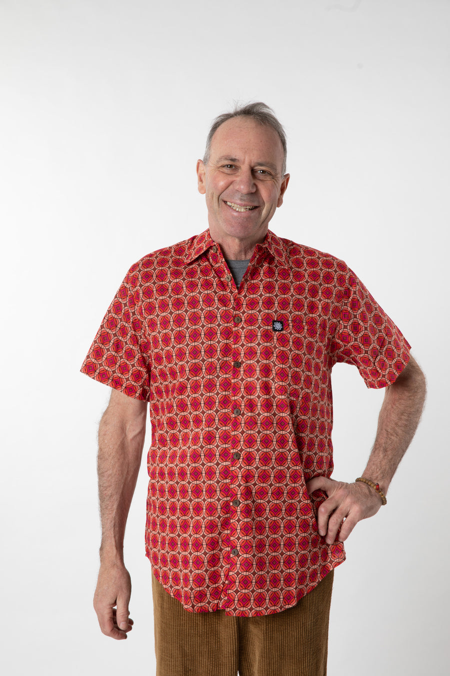 Ross is wearing size M printed cotton button up shirt in red geo