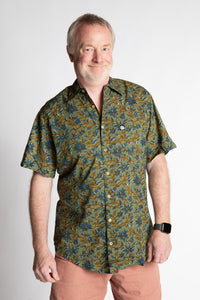 Chris, 5'7", wearing the LaLa Printed Cotton Button Up in Sage Floral, size M