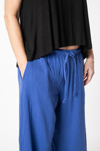 Tish is wearing cotton pants in cobalt