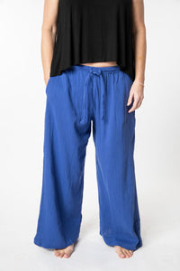 Tish is wearing cotton pants in cobalt