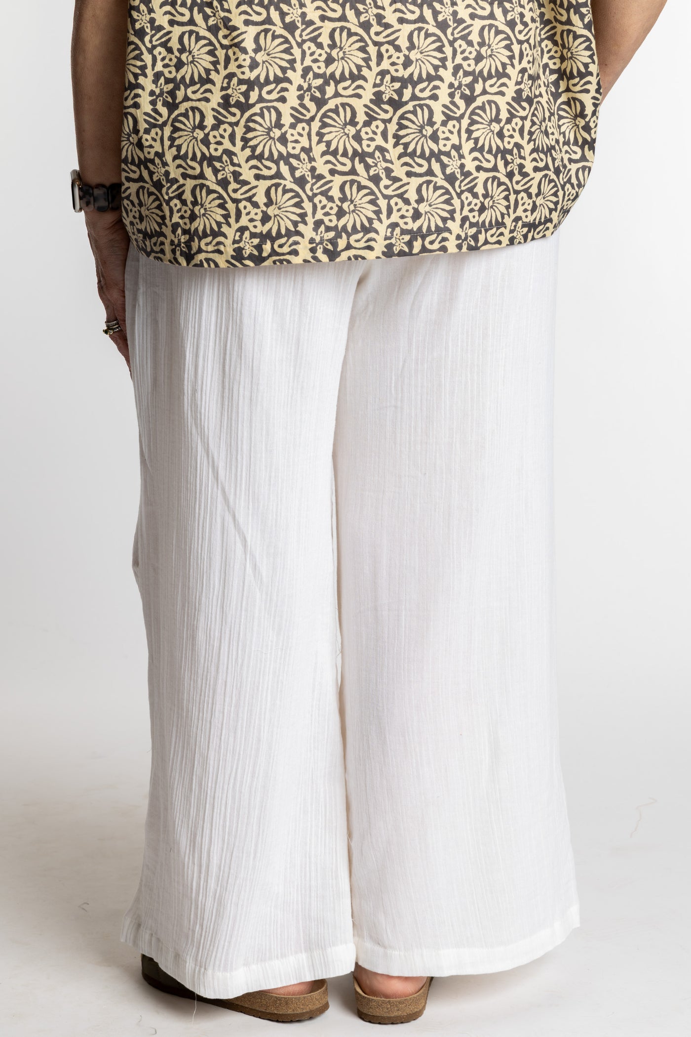 Betty is wearing the white summer wide leg linen-style pants