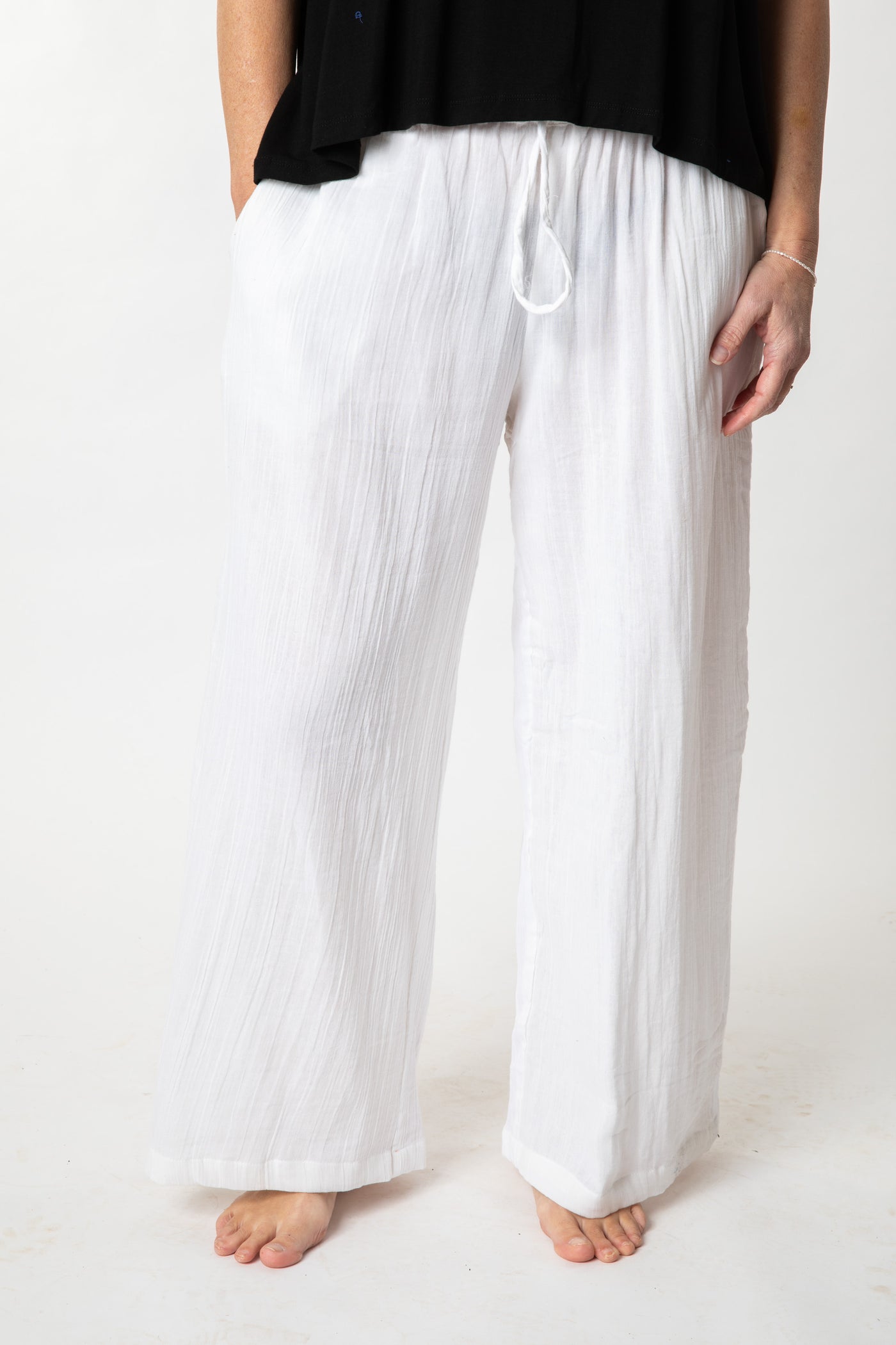 Tish is wearing cotton pants in ivory