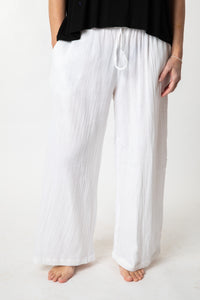 Tish is wearing cotton pants in ivory