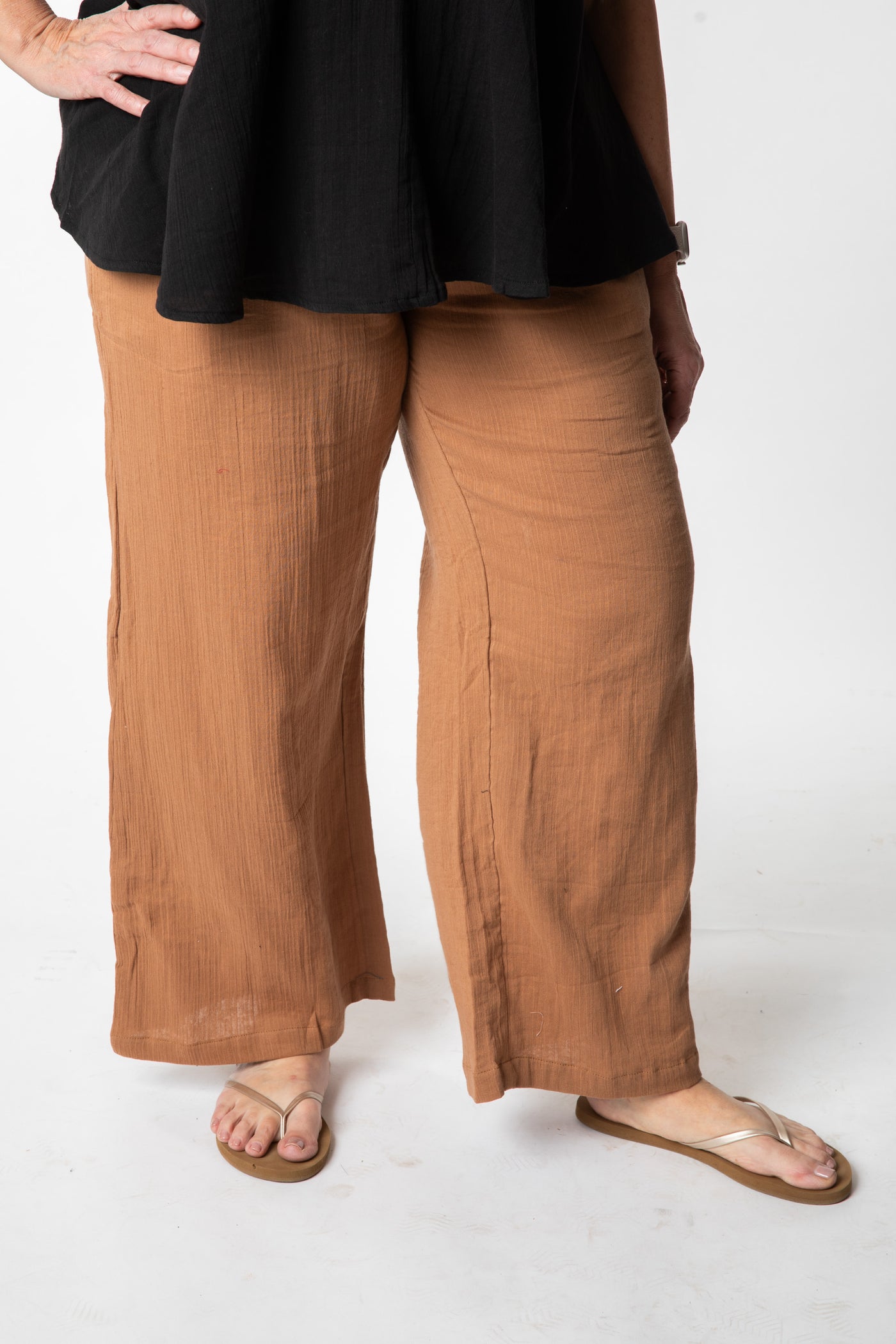Betty is wearing cotton pants in tan