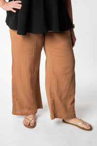 Betty is wearing cotton pants in tan