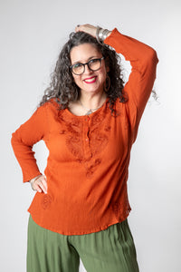 Susan is wearing size M cotton kurta in rust