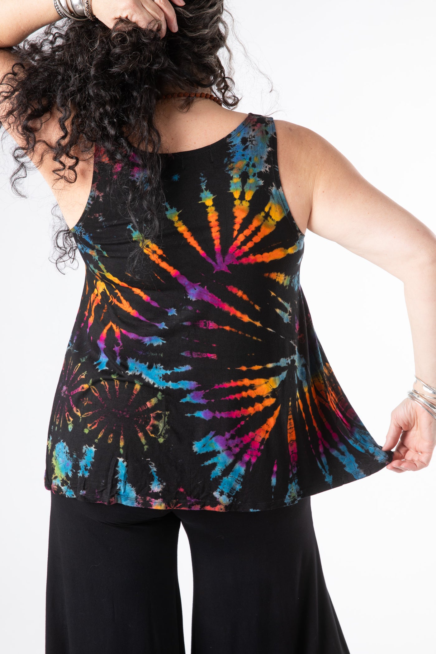 Susan is wearing a tie dye tank top in black rainbow