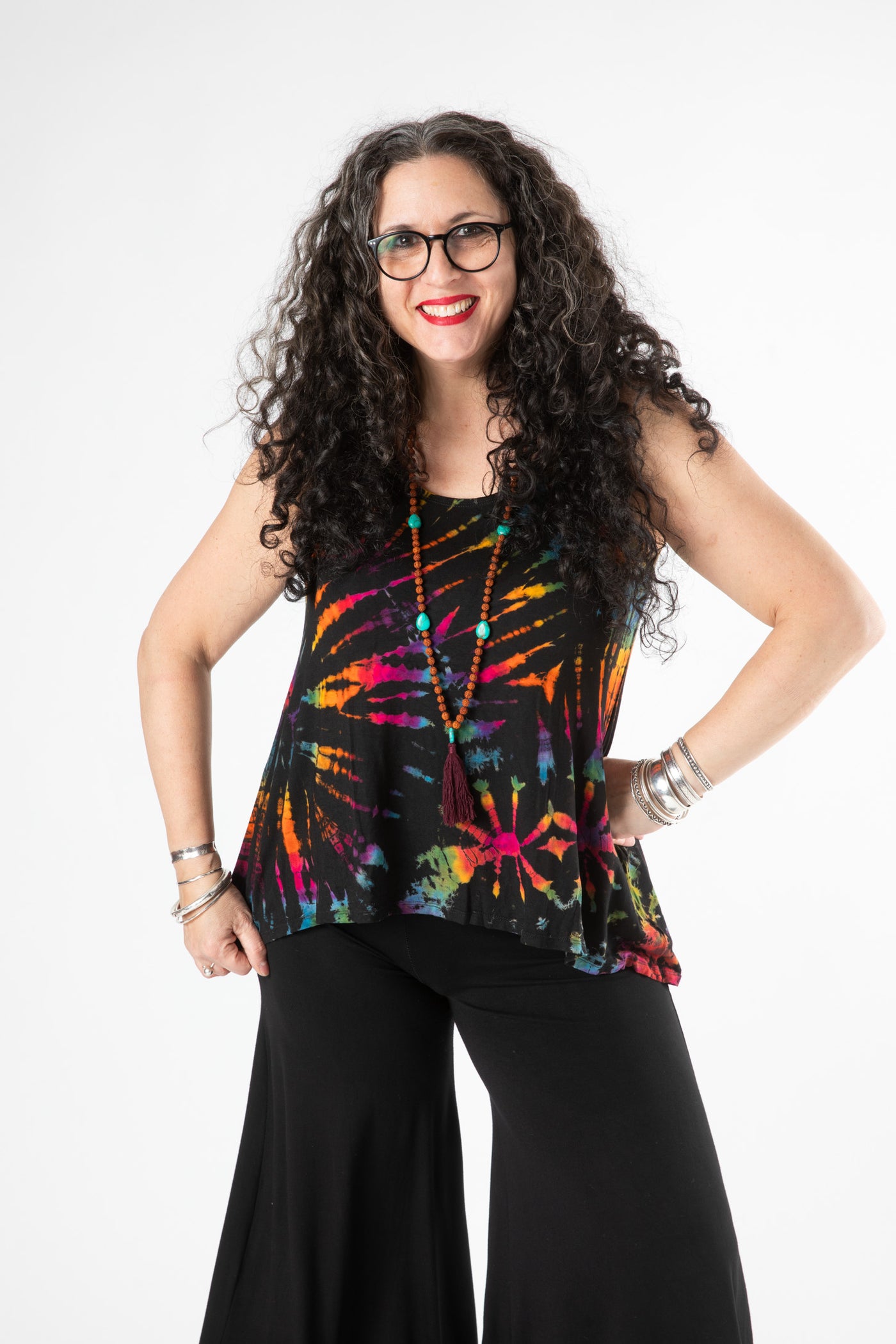 Susan is wearing a tie dye tank top in black rainbow