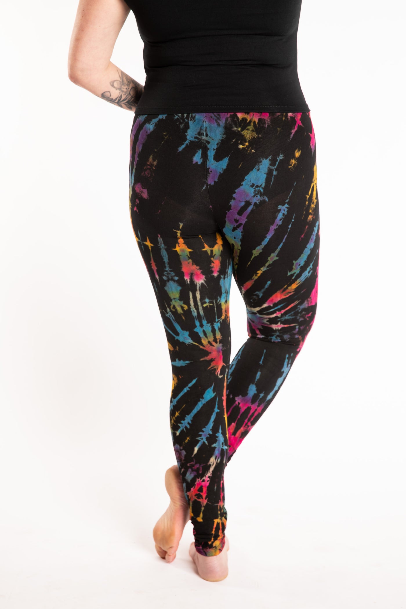 Maggie is wearing the size M/L Black Rainbow Tie Dye Leggings