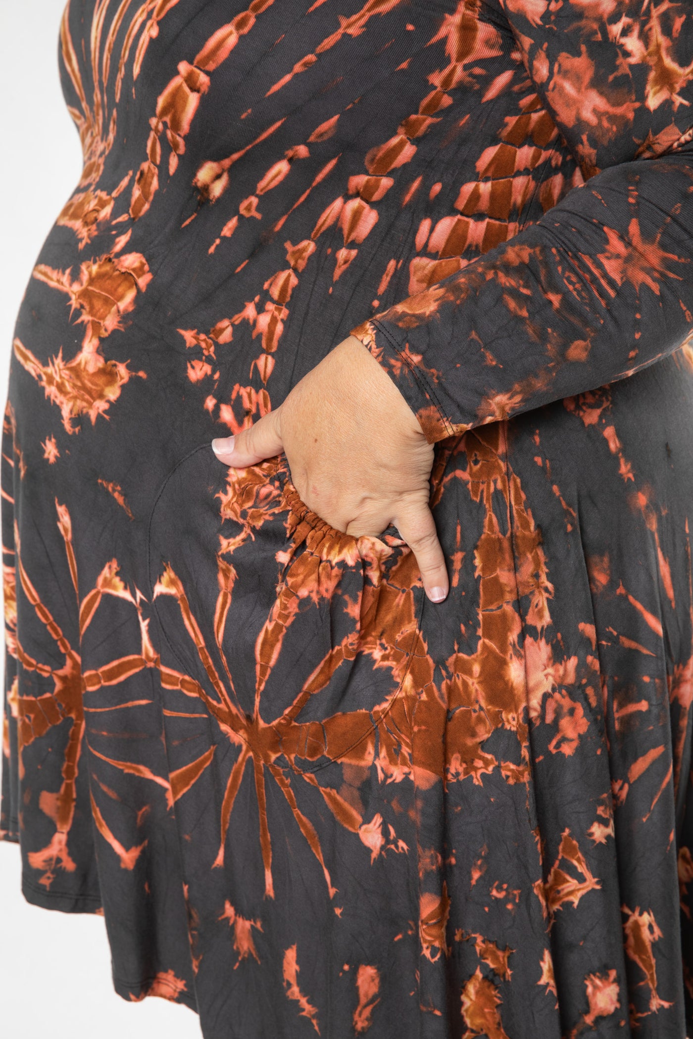 Angel is wearing a long sleeve tie dye dress in gray