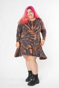 Angel is wearing a long sleeve tie dye dress in gray