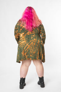 Angel is wearing a long sleeve tie dye dress in green