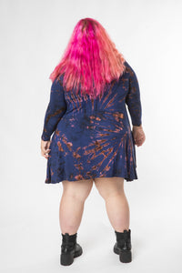 Angel is wearing a long sleeve tie dye dress in navy