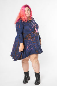Angel is wearing a long sleeve tie dye dress in navy