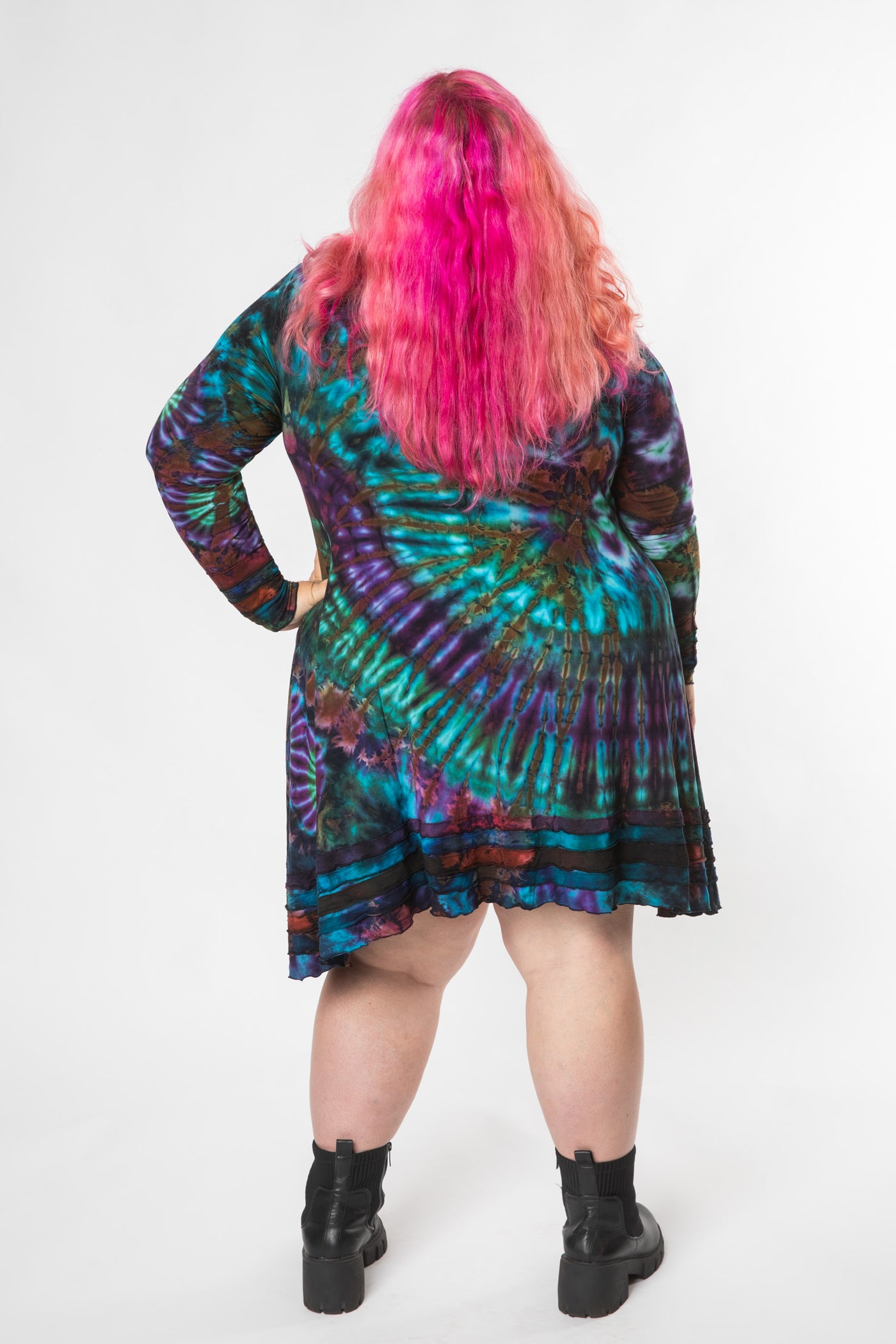 Angel is wearing long sleeve tie dye dress in ocean