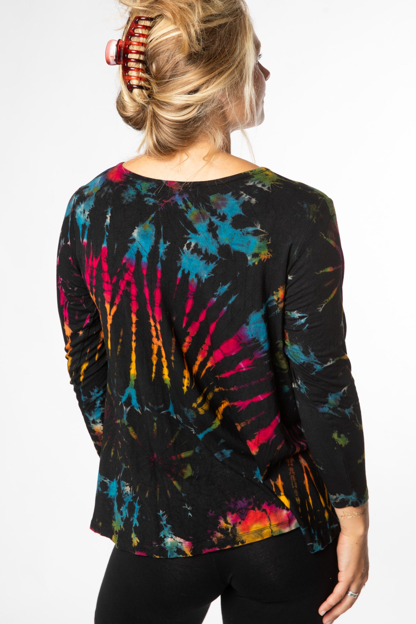 Sophie is wearing long sleeve tie dye top in black rainbow
