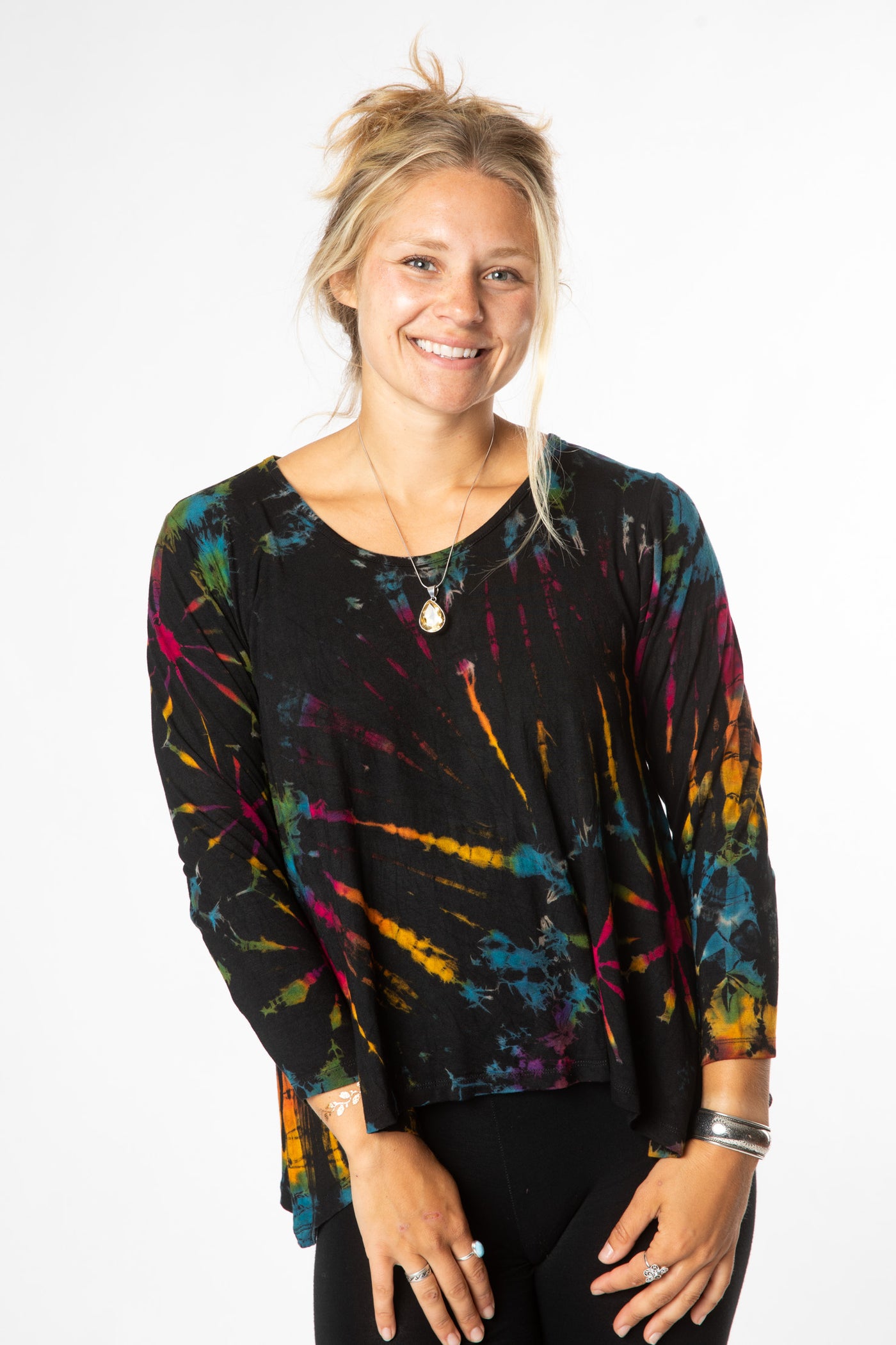 Sophie is wearing long sleeve tie dye top in black rainbow