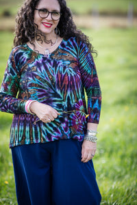 Susan is wearing long sleeve tie dye top in ocean