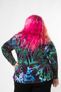 Angel is wearing long sleeve tie dye top in ocean